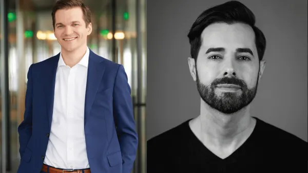 An image of two individuals with the one on the left wearing a blue suit. The person on the right is in black and white with a dark shirt on.