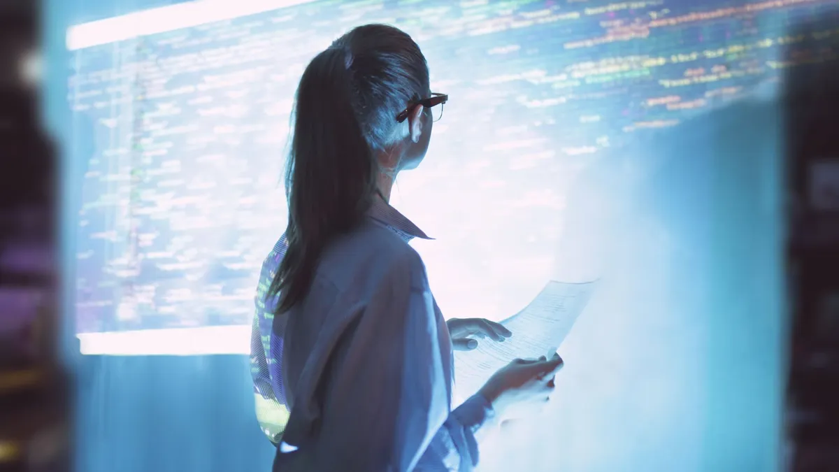 Person staring at code wall