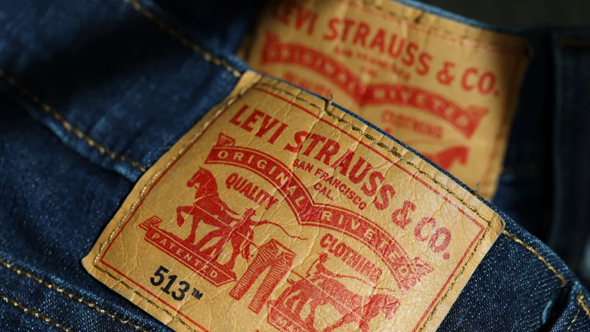 back patch on a pair of blue jeans in red lettering