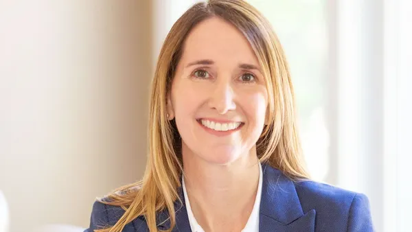 A photogrpha of a person smiling at the camera