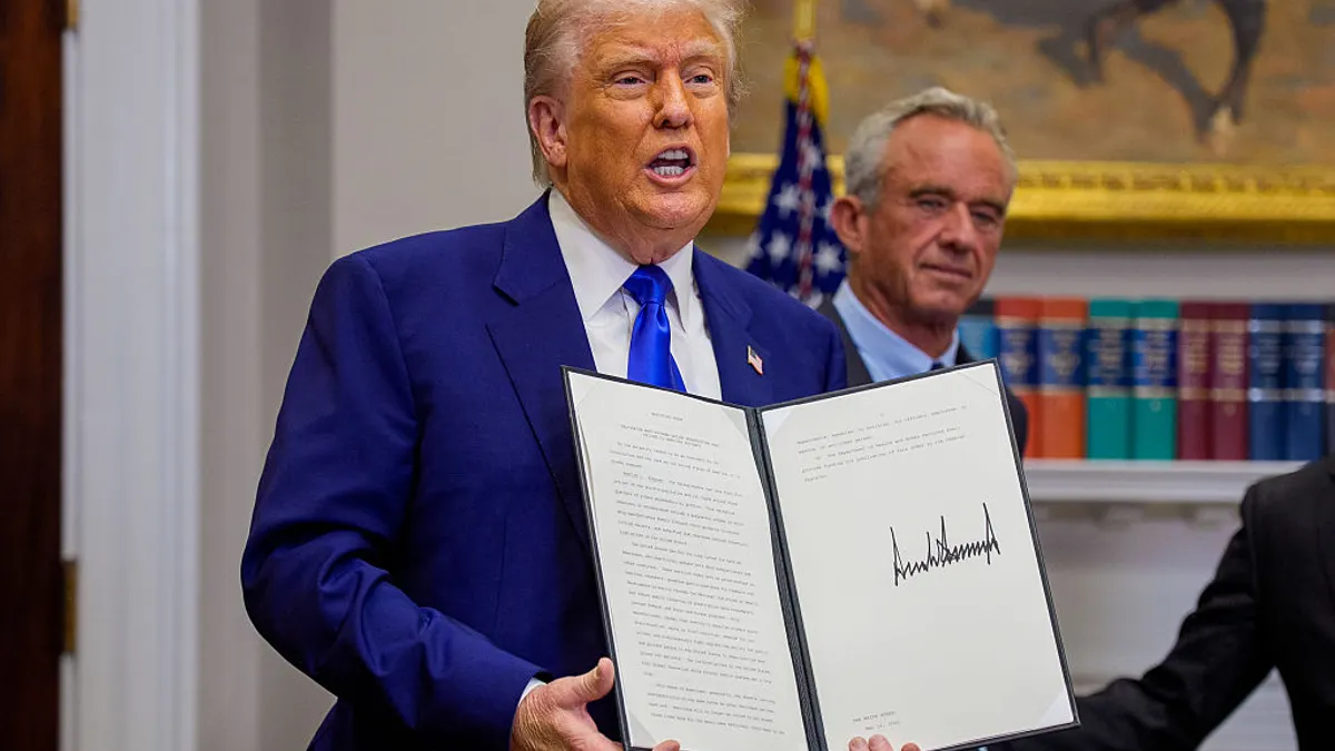 President Donald Trump displays drug price executive order.