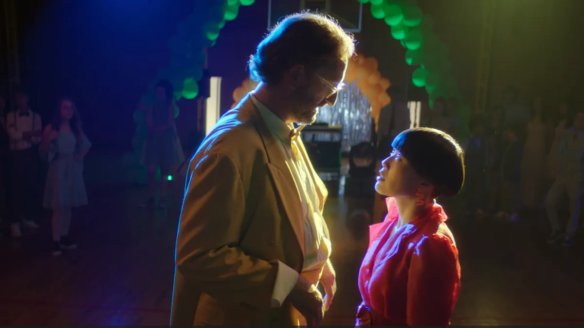 Actors Eric Wareheim and Atsuko Okatsuka stand next to each other on a prom dance floor