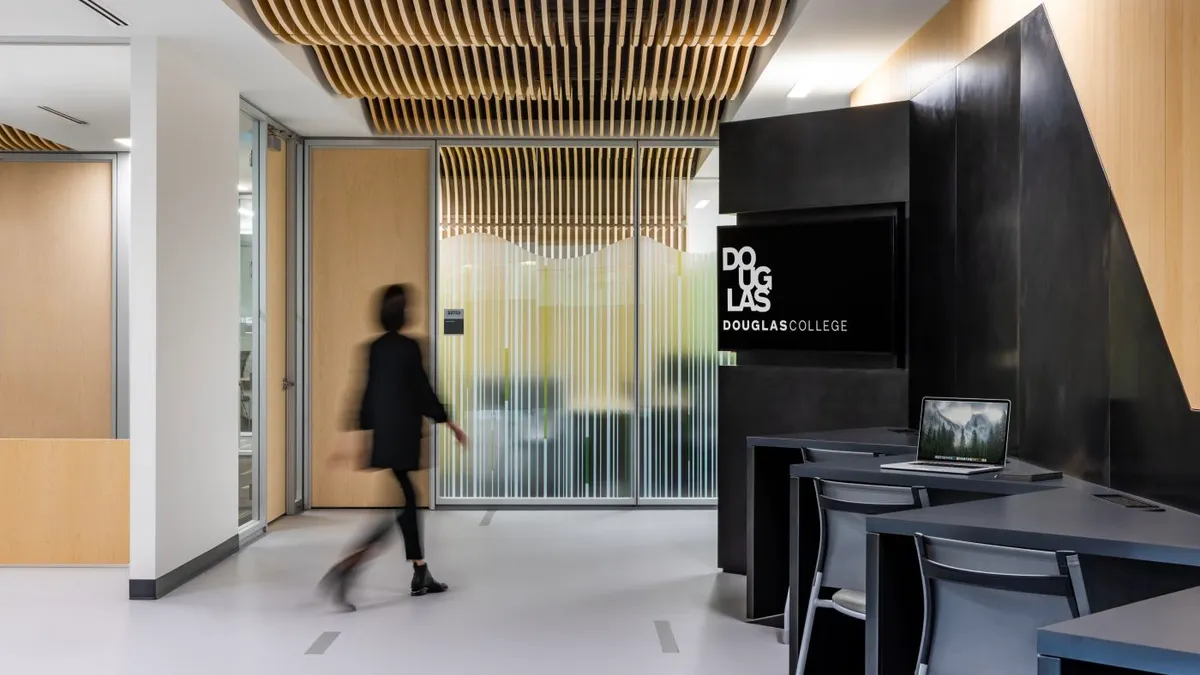 Woman walking through a Douglas College lobby