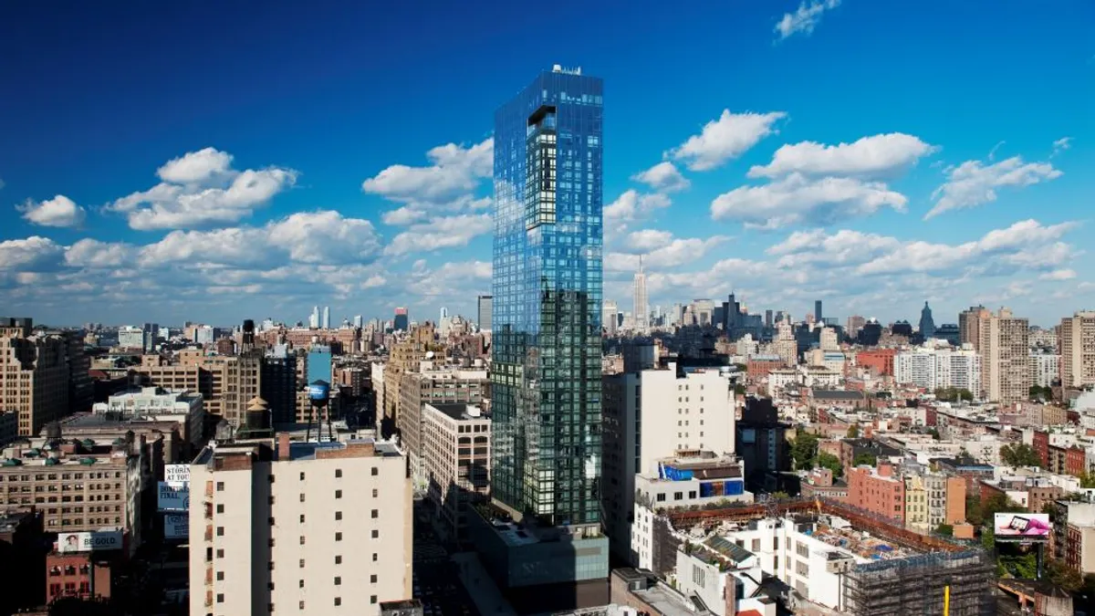 The exterior of Delano SoHo New York with the New York City skyline in the background.