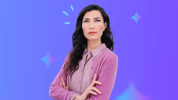 middle aged woman with dark hair and pink sweater