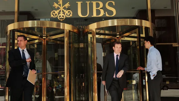 People enter and exit UBS Bank in NYC.