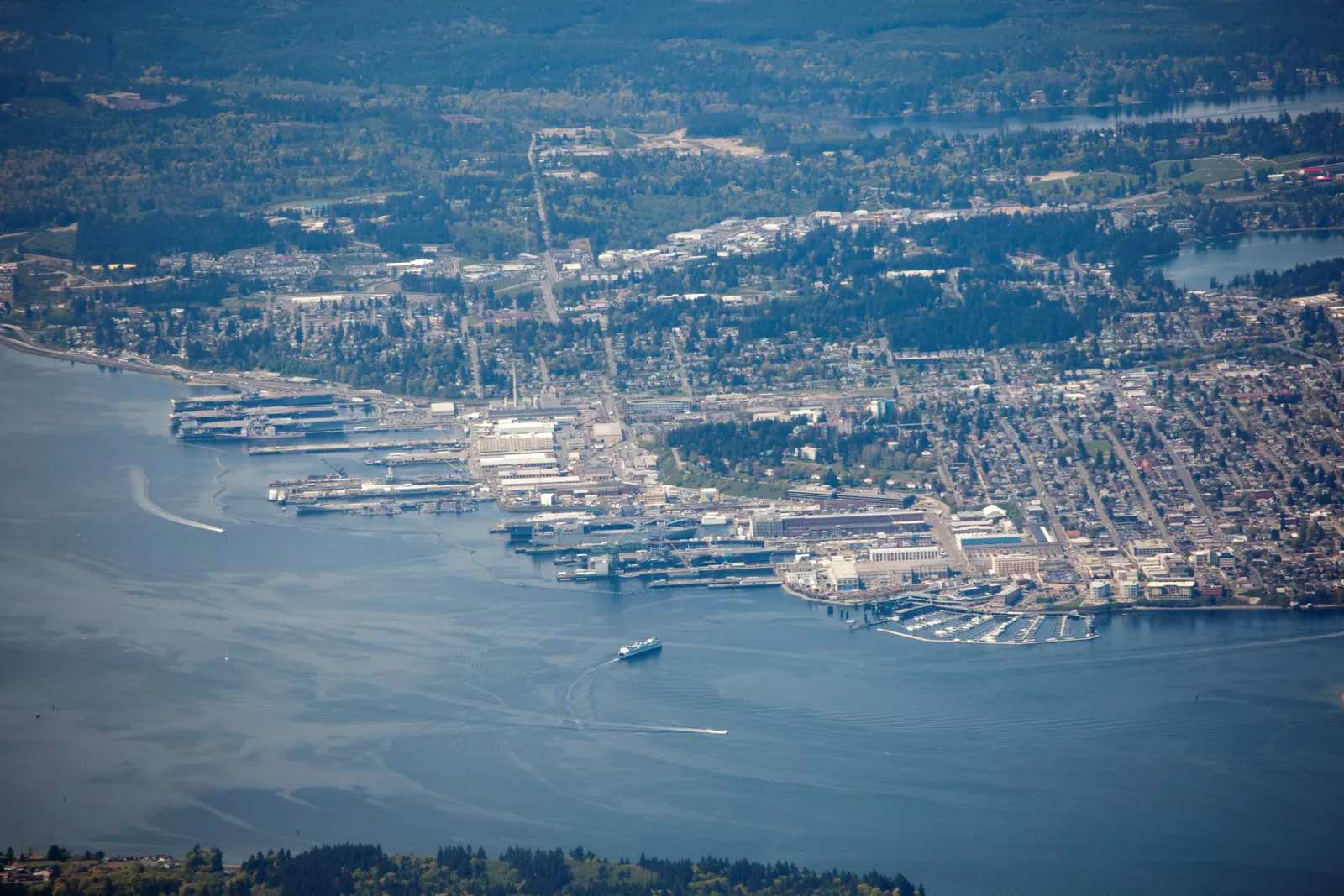 An aerial overview of a city located along an active port.