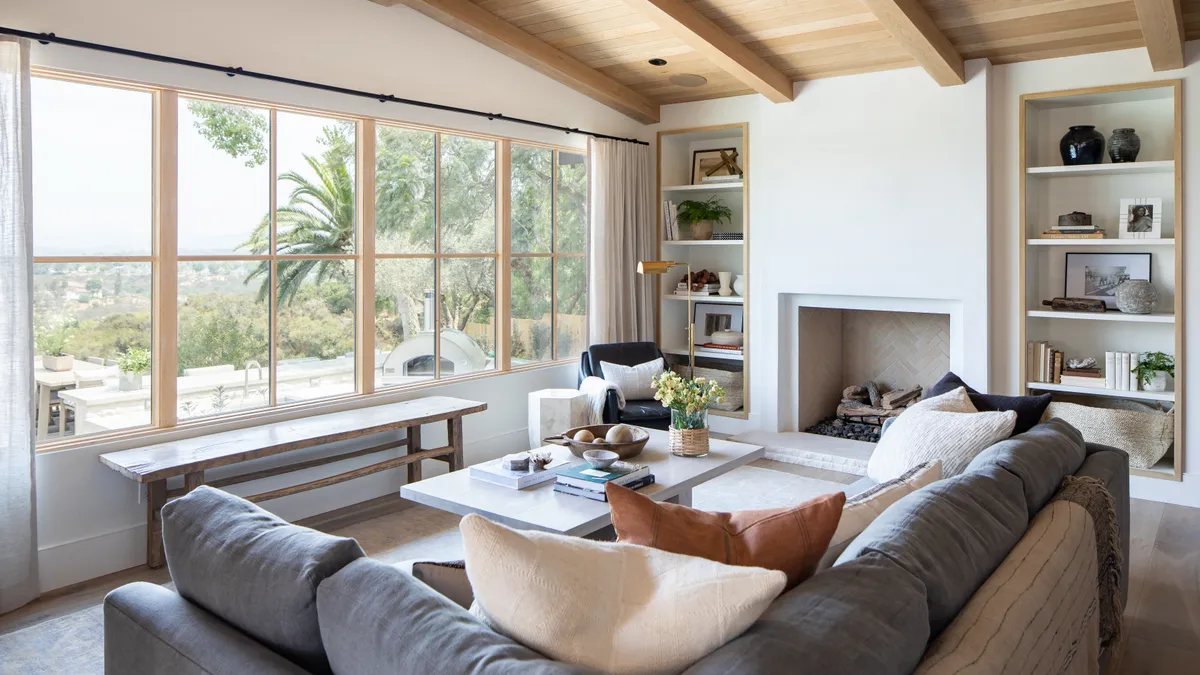 A living room with white oak windows.