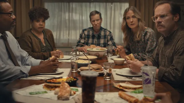 A group of people around a dining room table in a Taco Bell ad