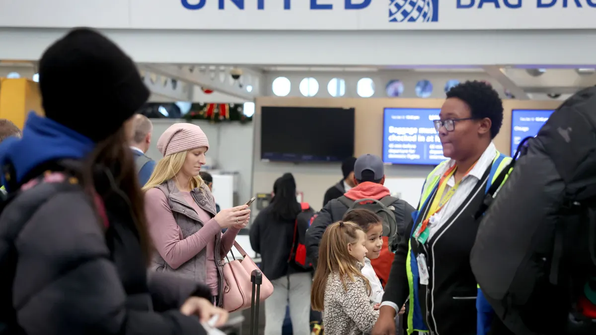 Travelers check in at the airport.