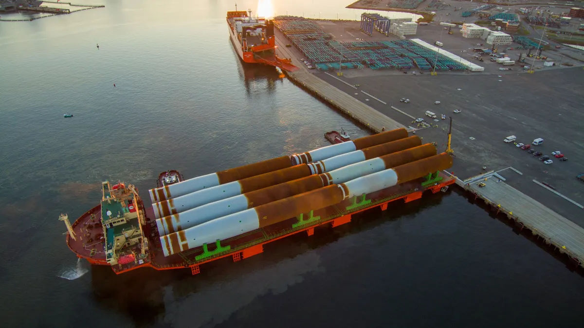 A large cargo ship with monopile foundations