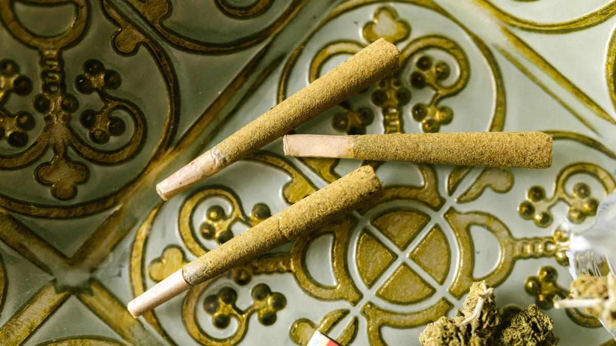 Three joints lay on top of a tiled surface