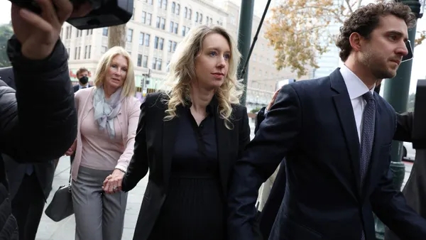 Former Theranos CEO Elizabeth Holmes (center) arrives at federal court with her partner Billy Evans and mother Noel Holmes on November 18, 2022 in San Jose, California.