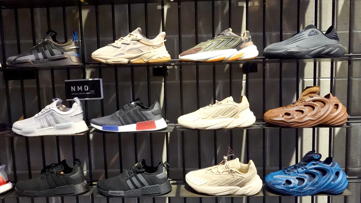 Sneakers are displayed in a grid formation on a wall.