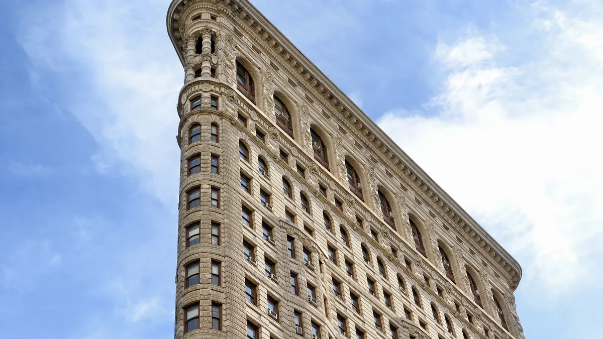 A low-angle view of the Flatiron Building in New York City.