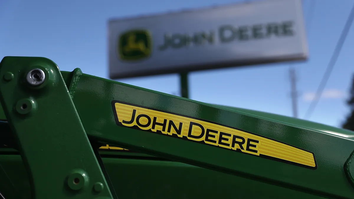 A John Deere logo is seen on a green tractor