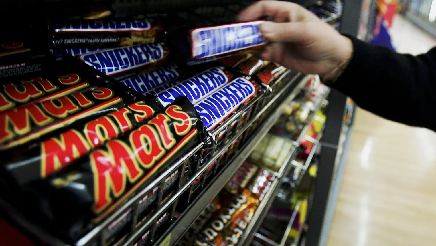 A customer picks up a Snickers Bar in a supermarket August 18, 2005 in Sydney, Australia.