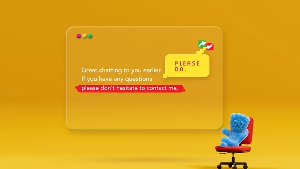 A screen displaying corporate text against an orange background. A blue Sour Patch Kid gummy sits in an office chair to the right