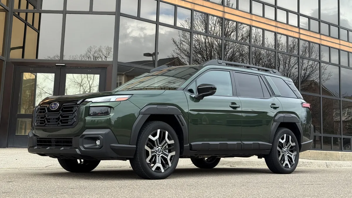 An exterior photo of the 2026 Subaru Outback Touring XT, with a building in the background.