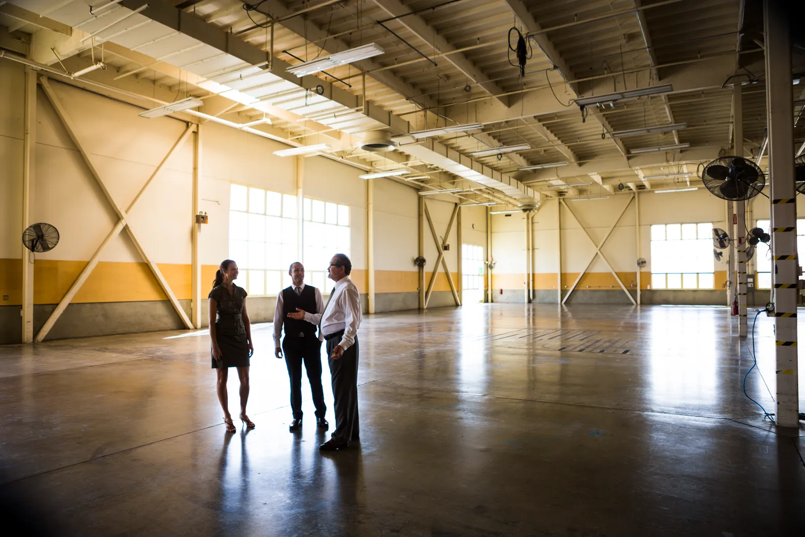 Business people talk in an empty office warehouse.