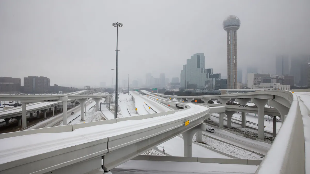 Pedestrians walk snowy streets in downtown streets during rush hour in downtown Dallas.