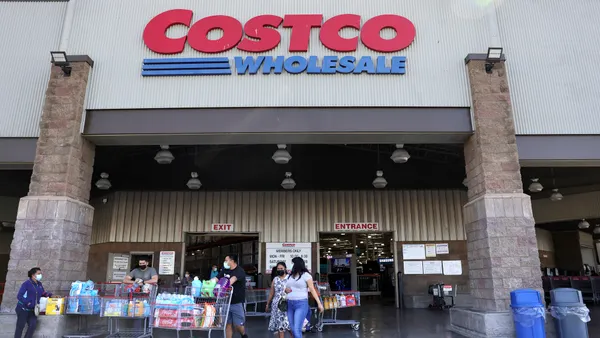 People enter and leave a Costco.