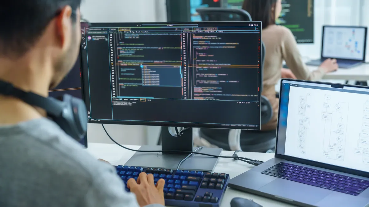 a software developer writing code at his desk