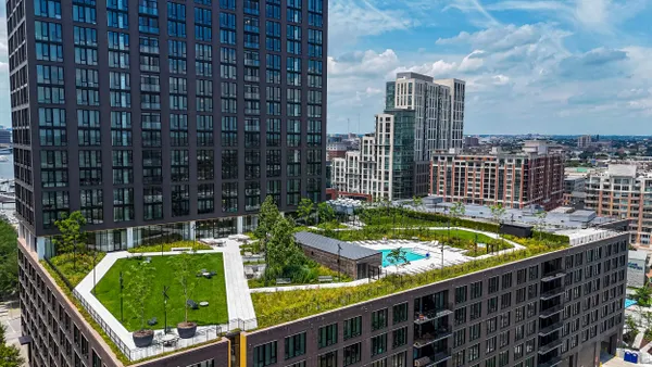 Picture of high rise apartment building with courtyard above seventh floor.