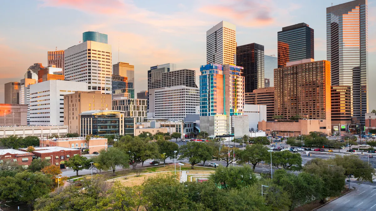A view of the Houston skyline shows a park and buildings
