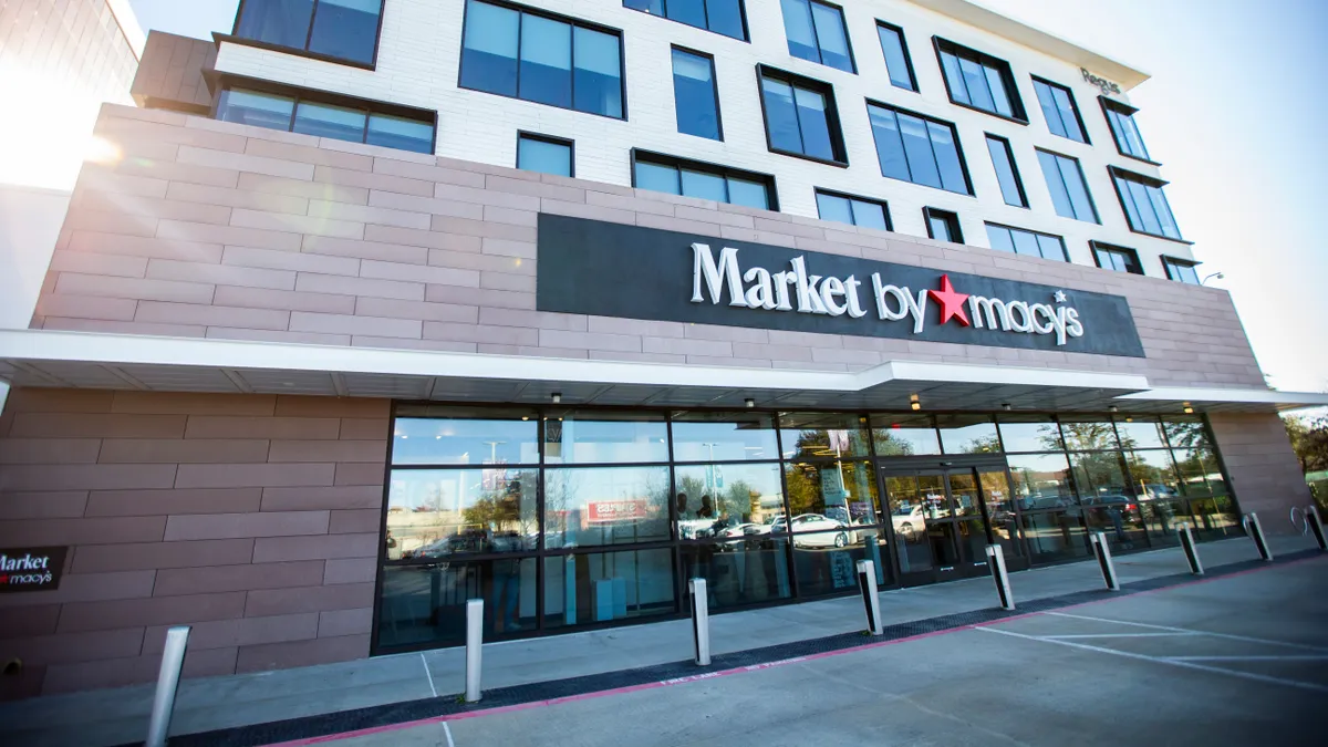 A ray of sunshine peeks out from the left corner of a storefront with a "Market by Macy's banner.