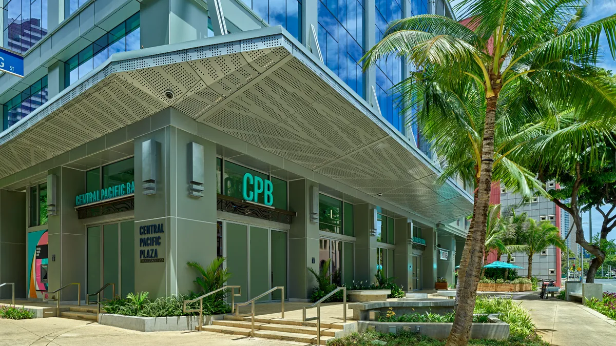 A green Central Pacific Bank sign hangs above the bank's headquarters in downtown Honolulu.