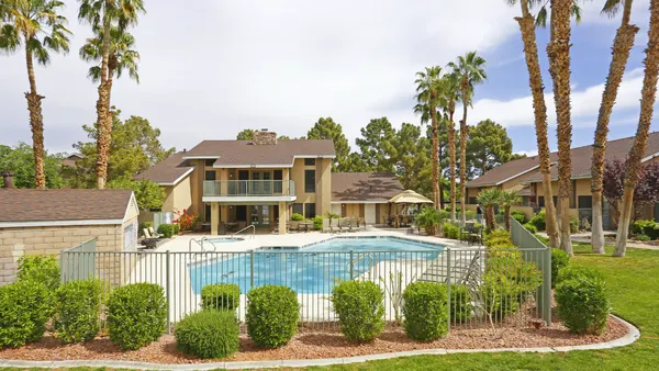 Pool with brown apartments in the background