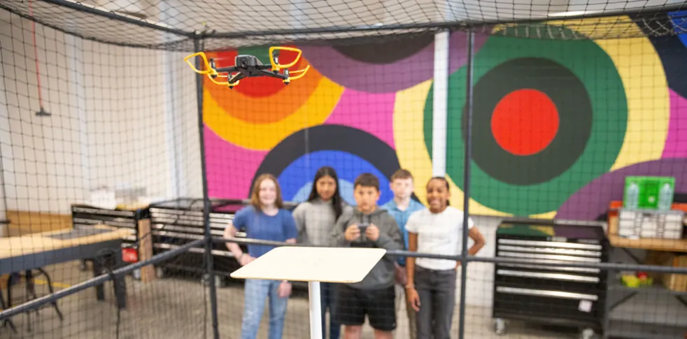 Group of students experimenting with drone project.