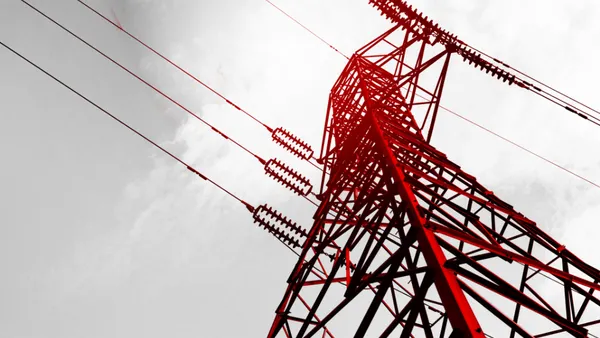 electricity transmission tower with power lines extending into the sky.