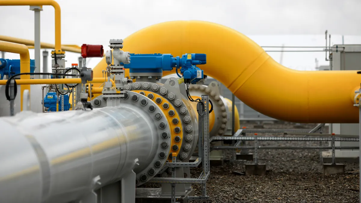 Industrial equipment (pipes, manometer/pressure gauge, levers, faucets, indicators) in a natural gas compressor station.