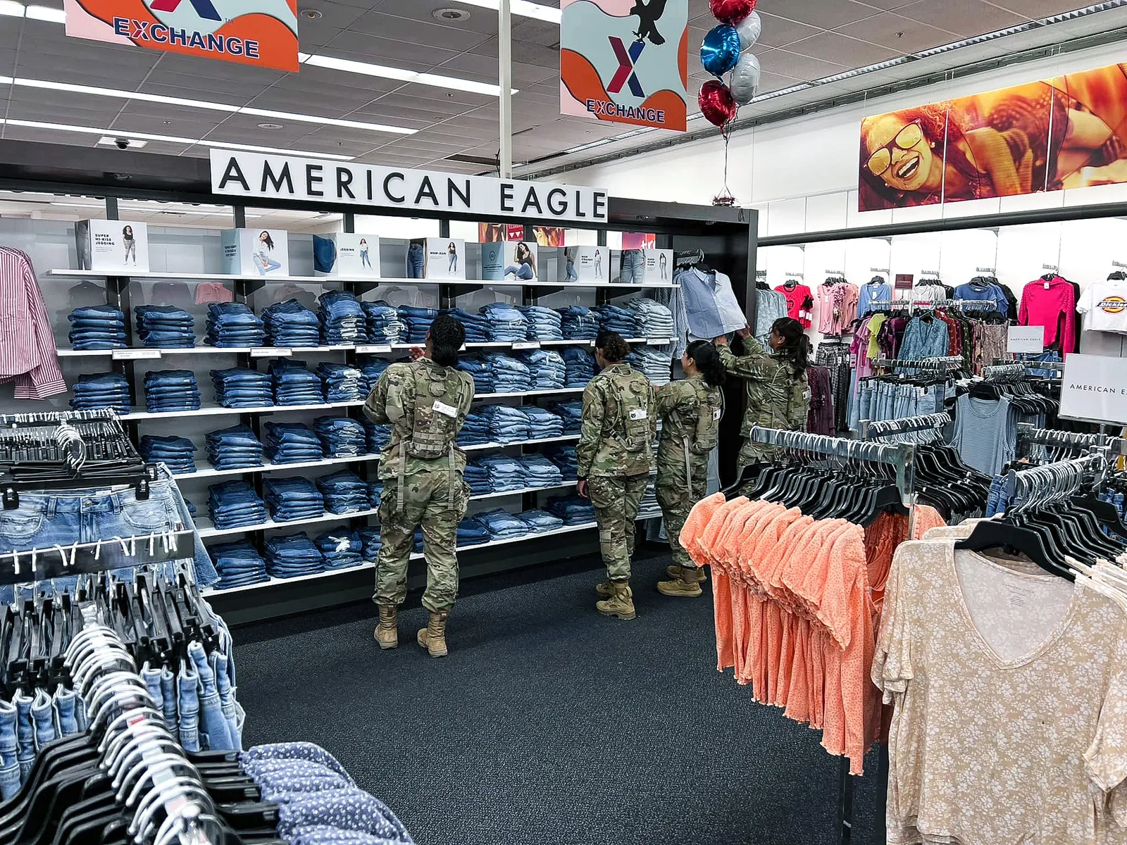 Military members shop at an Old Navy display at an Exchange store