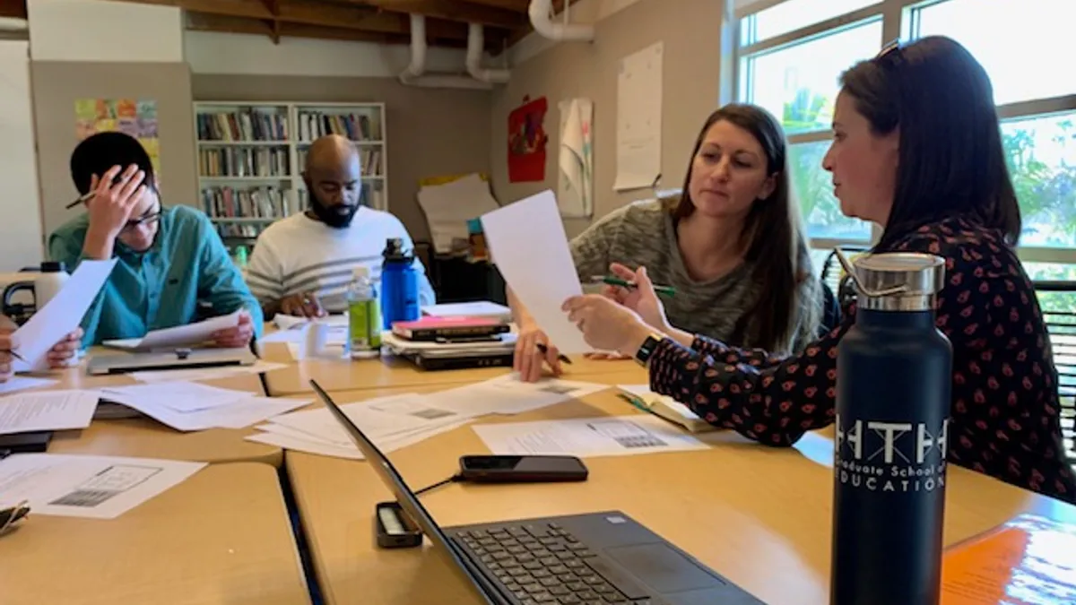 Sarah Fine, right, meets with students in the High Tech High Graduate School of Education apprenticeship program