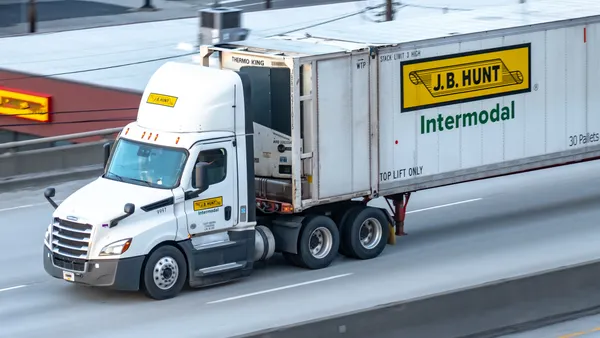 A semi-truck driving on a freeway.