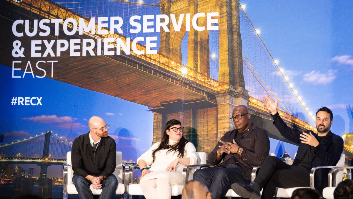 Three people talk on a panel.