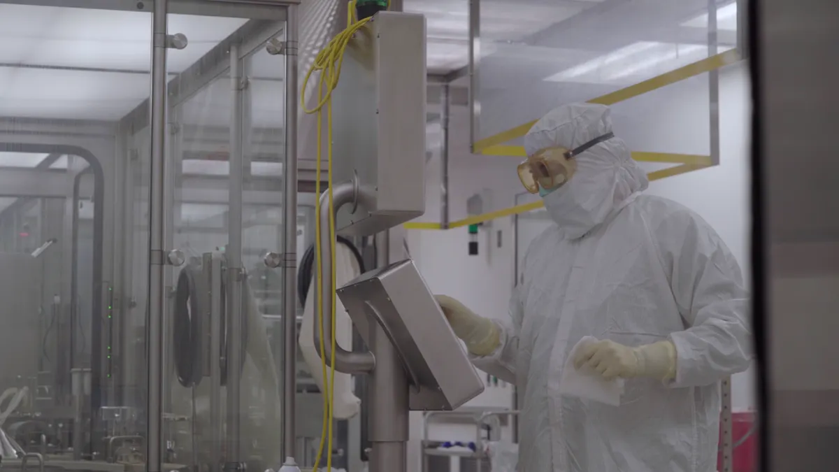 AstraZeneca technicians work on manufacturing a vaccine