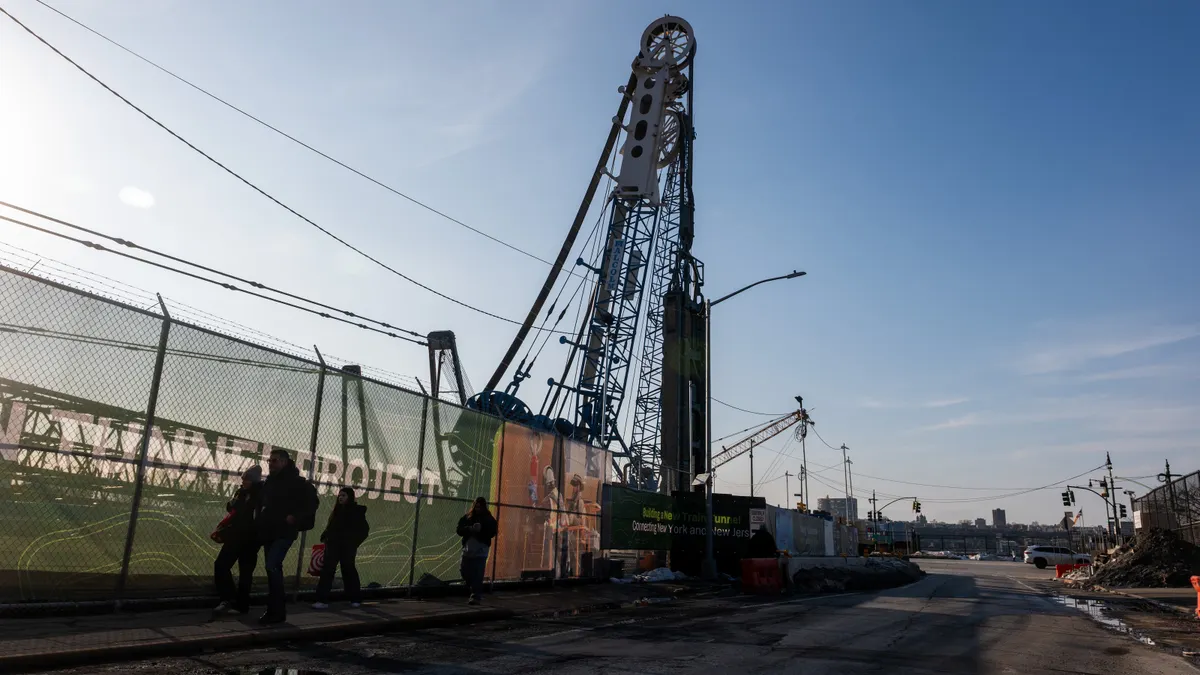 People walk past a worksite for the Gateway Hudson Tunnel on February 16, 2026, in New York City.