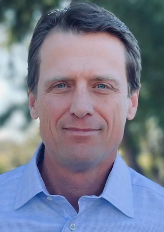 James Schaffer is seen in a professional headshot.