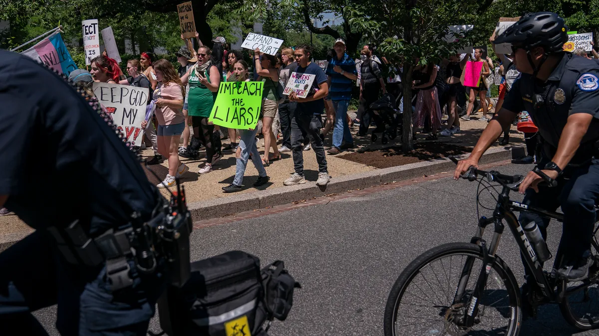 WASHINGTON, DC - JUNE 29: U.S. Capitol Police follow an abortion-rights protest in front of the Dirksen Senate Office Building on June 29, 2022 in Washington, DC. The Supreme Court's decision in Dobbs