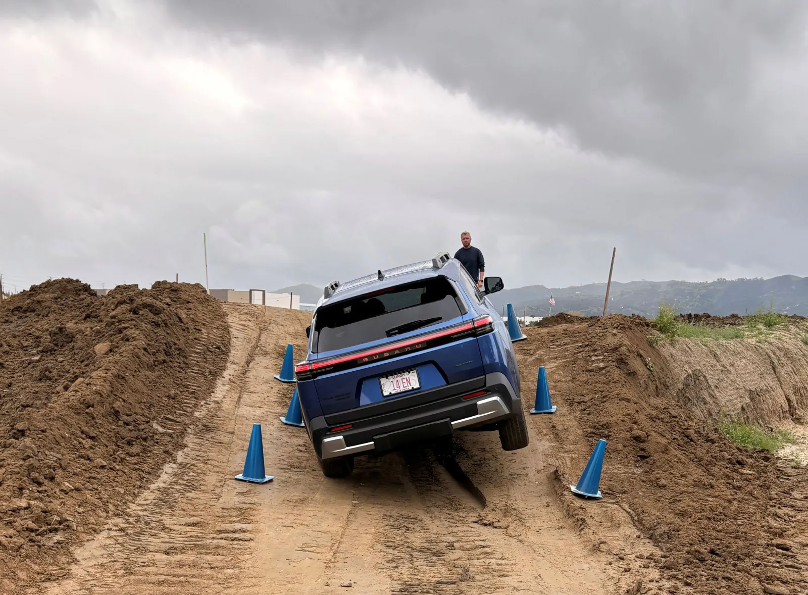 A 2026 Subaru Trailseeker is driving, right-side wheels up, on a dirt off-road course in California.