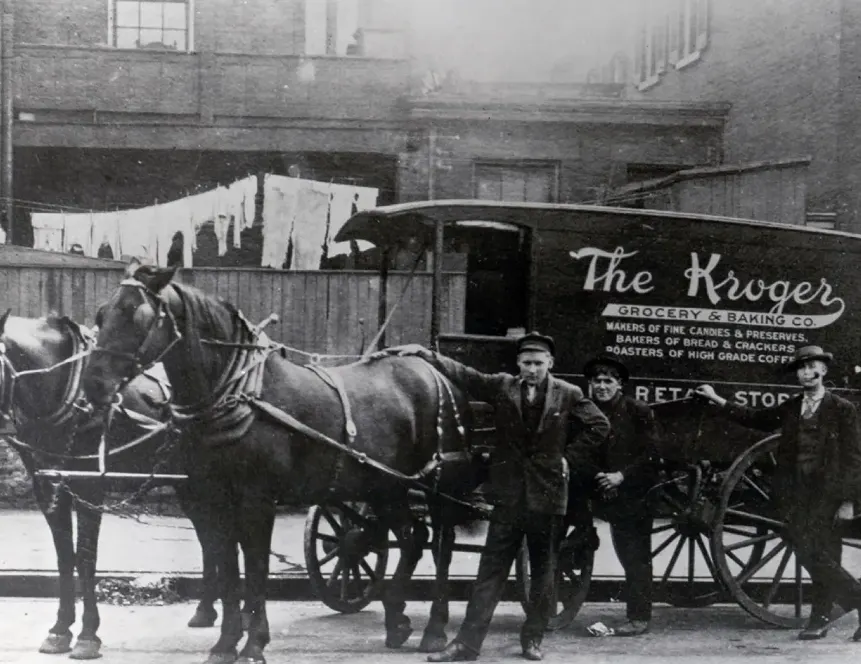A black-and-white photo of a horse-drawn vehicle with the words "The Kroger Grocery &amp; Baking Co." on the side