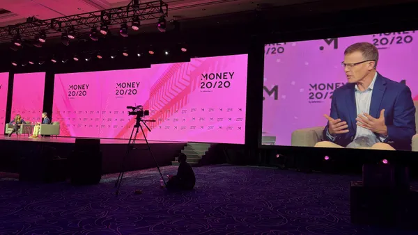 Tim Ryan, Citi's head of technology and business enablement, is shown on a big screen while he speaks on stage at a conference.