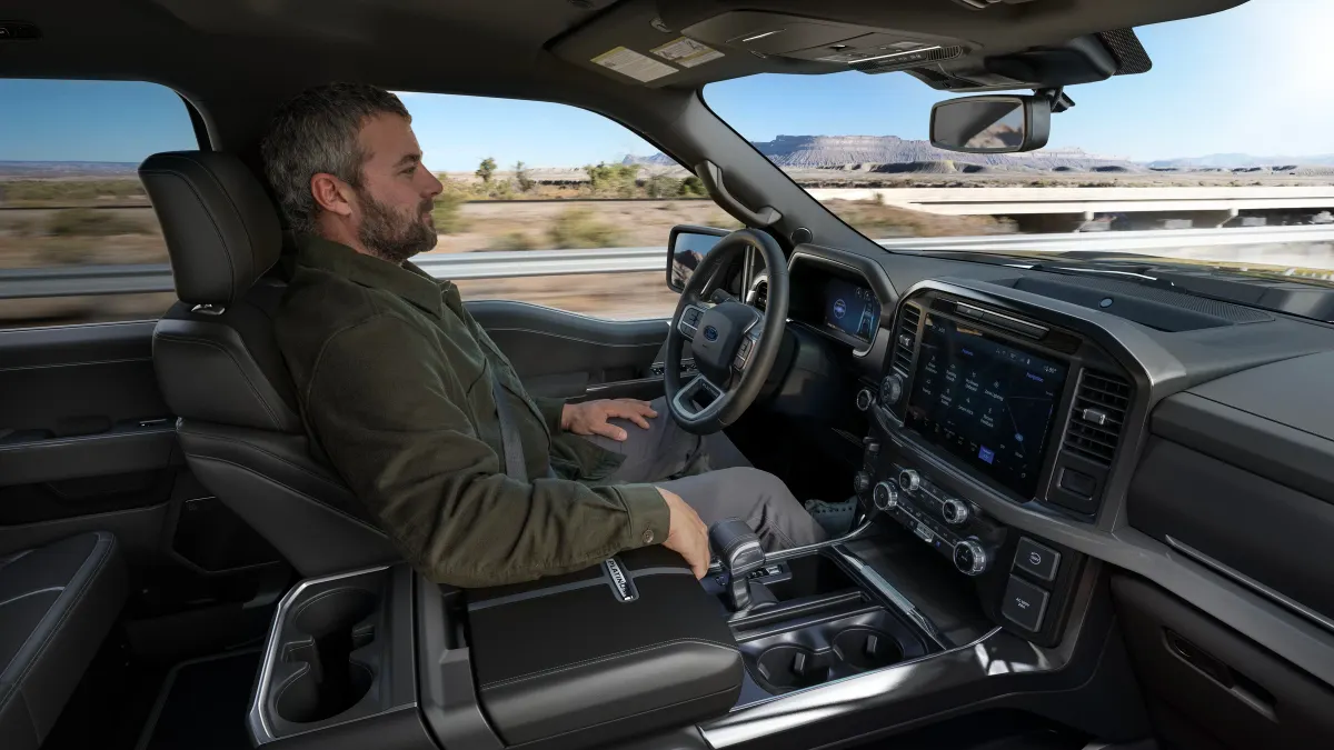 A driver using Ford's BlueCruise hands-free highway driving feature in a F-150 Platinum pickup.