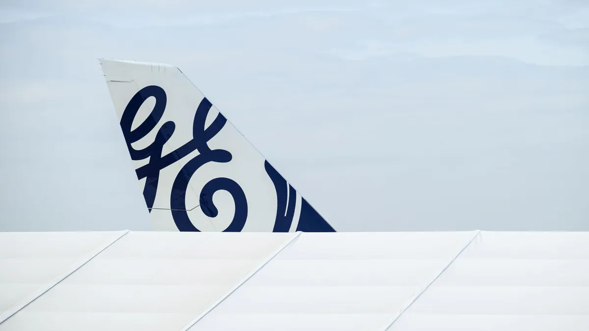 The General Electric logo is seen on the tailfin of an aircraft.