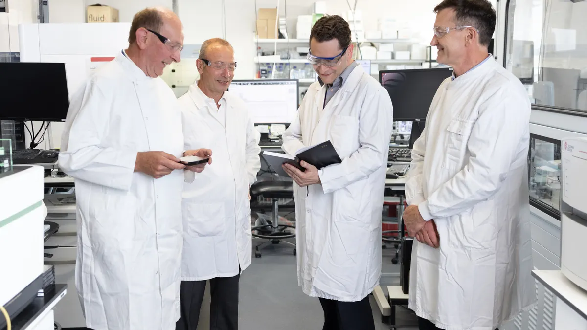 Myricx Bio co-founders Andrew Bell, Roberto Solari and Ed Tate, and CEO Robin Carr in a laboratory.