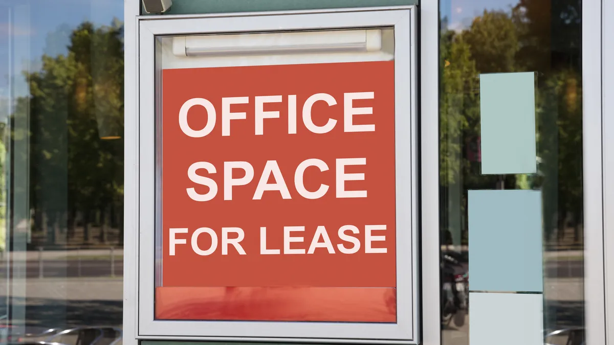 A closeup of a signboard outside a modern office building